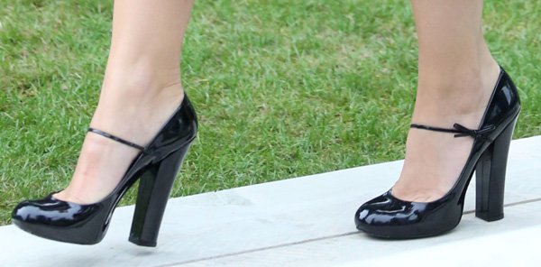 Daisy Lowe completes the look with glossy black Mary Jane pumps, their slim strap and chunky block heel balancing feminine polish with sturdy, modern lift