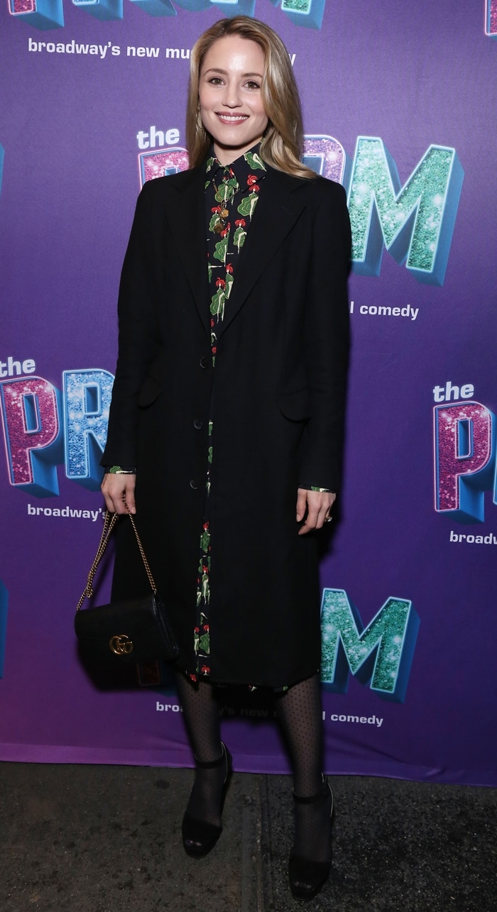 Dianna Agron brought polished off-duty elegance to Broadway’s The Prom benefit at the Longacre Theatre on April 9, 2019, pairing a tailored black coat over a patterned dress with sheer tights, classic black pumps, and a Gucci Marmont shoulder bag for a refined, city-ready finish