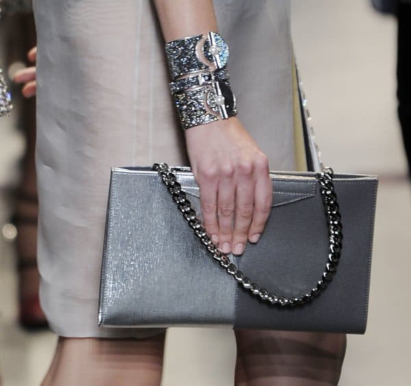 Fendi's sleek metallic clutch with chain straps and glittering wrist cuffs showcased during Milan Fashion Week Spring/Summer 2014
