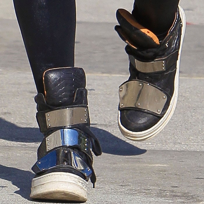Kat Von D is rocking edgy, heavy metal-inspired sneakers with shiny metallic straps and sleek black leather, perfectly complementing her bold, rebellious style while leaving Urth Caffé in Los Angeles on September 18, 2013