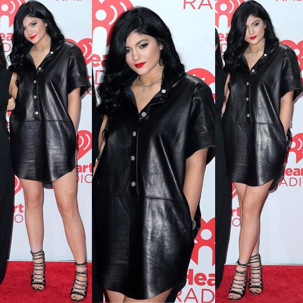 Kylie Jenner poses on the red carpet at the 2013 iHeartRadio Music Festival, wearing an Acne Studios Marla leather dress paired with stylish Aquazzura 'Amazon' lace-up sandals