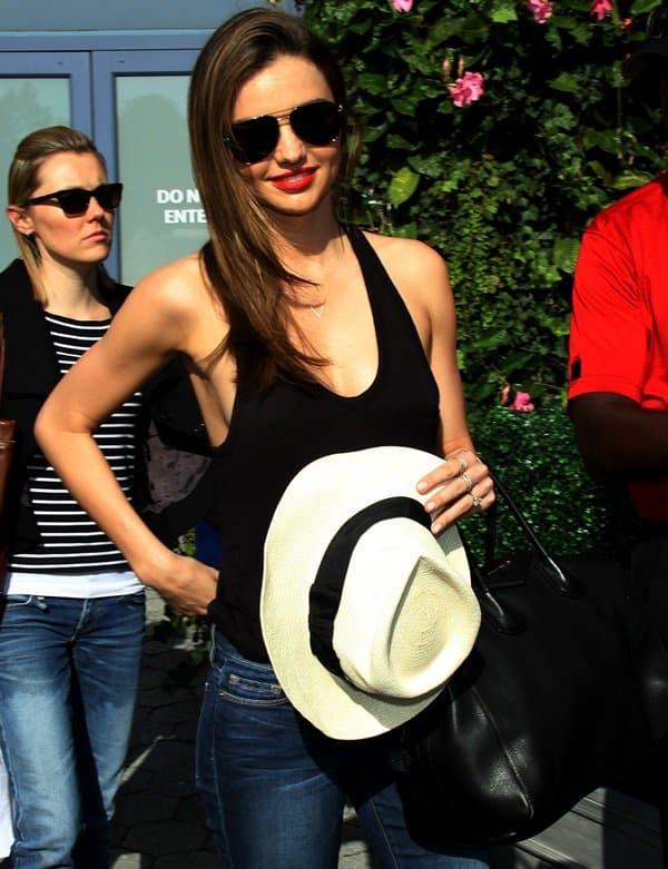 Miranda Kerr turning heads at the US Open in New York, showcasing her sophisticated style with a black top and Frame Denim jeans