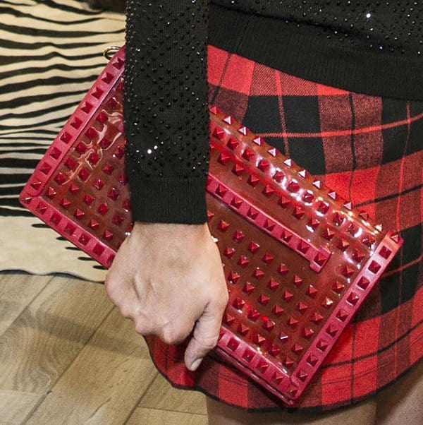 Nicky Hilton carrying a Valentino Rockstud rouge patent clutch at the Alice + Olivia presentation on September 9