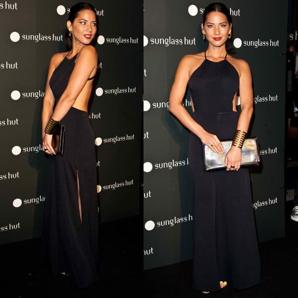Olivia Munn stuns in a backless black Reformation “Charles” maxi dress, subtly revealing yellow Sergio Rossi wedge sandals as she accessorizes with a metallic clutch and bold gold cuff at the Sunglass Hut Times Square opening in New York on September 10, 2013