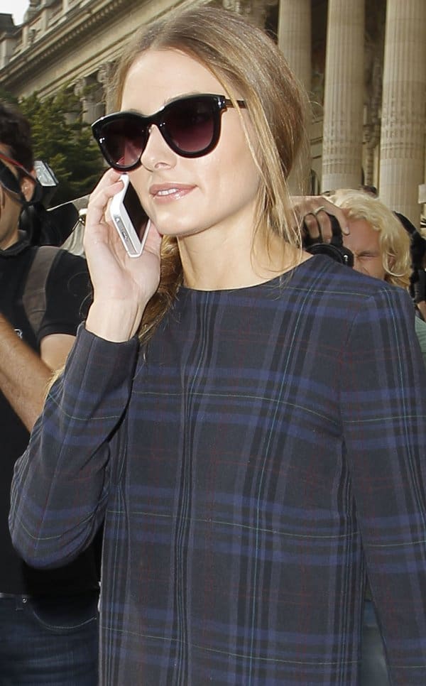 Olivia Palermo accessorizes with oversized sunglasses and a chic messy braid