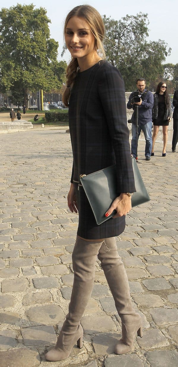 Olivia Palermo in a stylish plaid dress paired with knee-high boots at Paris Fashion Week