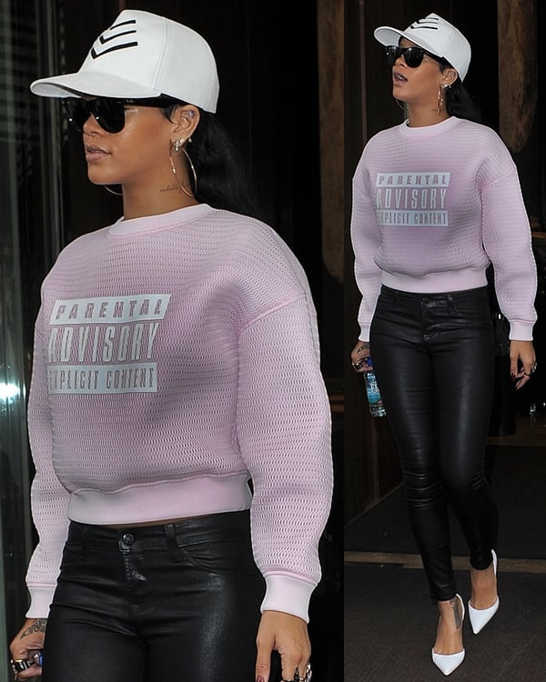 Rihanna steps out in London wearing an Alexander Wang "Parental Advisory" sweatshirt, black leather pants, and sleek white Manolo Blahnik pumps in London to film a talk show appearance