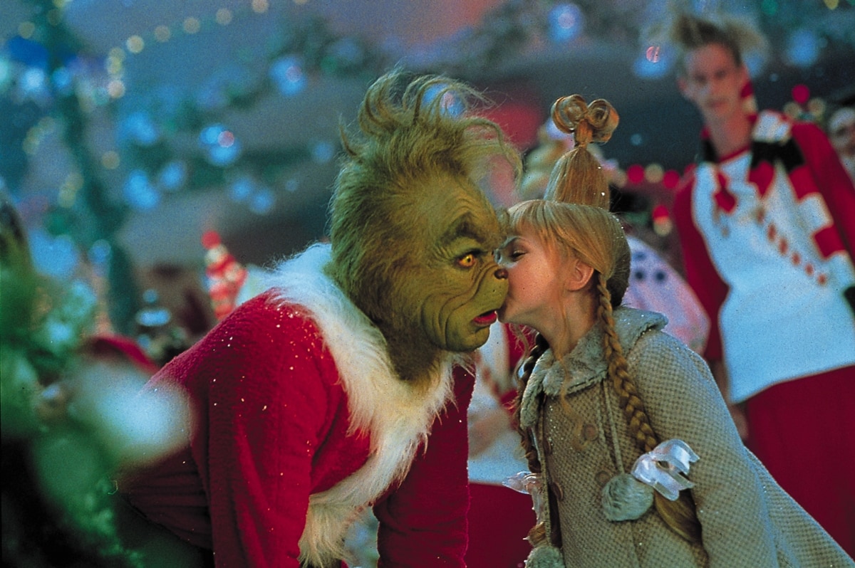 Cindy Lou Who, played by Taylor Momsen, shares a heartwarming moment with Jim Carrey's Grinch in How the Grinch Stole Christmas (2000)