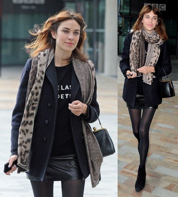 Alexa Chung spotted leaving BBC Breakfast Studios in Manchester on September 9, 2013, pairing a chic leopard print scarf with black suede ankle boots, sheer tights, and a structured peacoat for a polished fall look