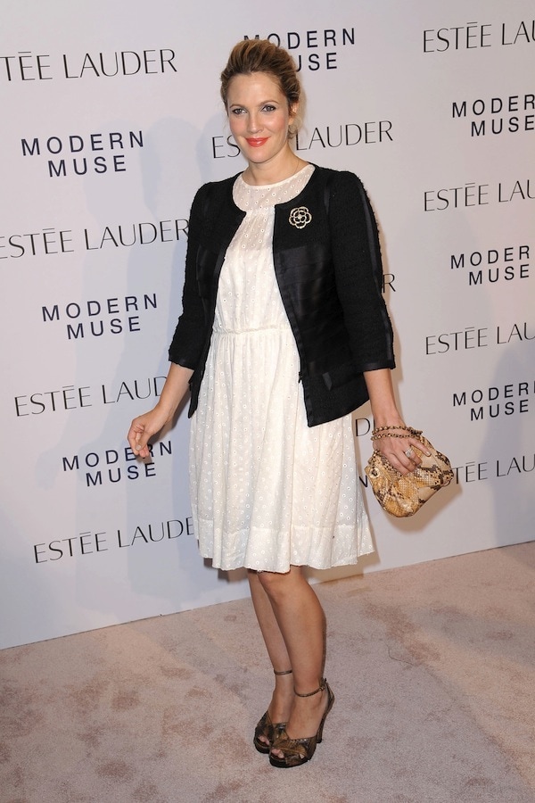 Drew Barrymore radiates charm in a white Marc Jacobs eyelet dress paired with a vintage Chanel jacket and snakeskin accessories at Estée Lauder’s Modern Muse launch
