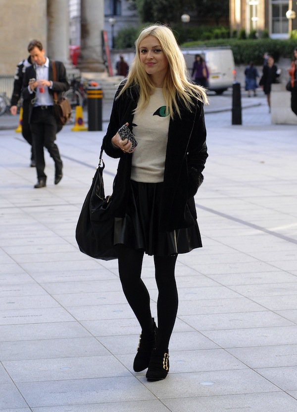 Fearne Cotton looking chic and opting for casual comfort in a cat jumper, a jacket, a leather skirt, black tights, and ankle boots