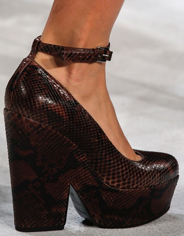 Dark brown snakeskin-textured platform pump featuring a dainty ankle strap and chunky block heel