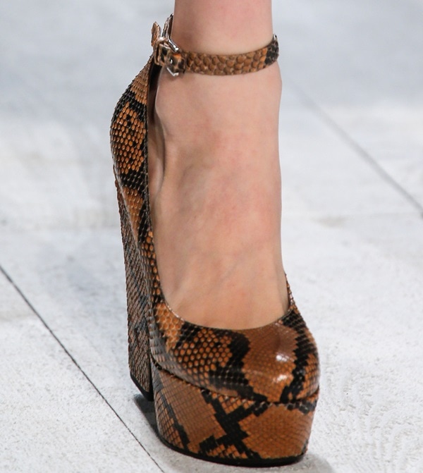 Brown snakeskin-textured platform pump with a sleek ankle strap and bold block heel