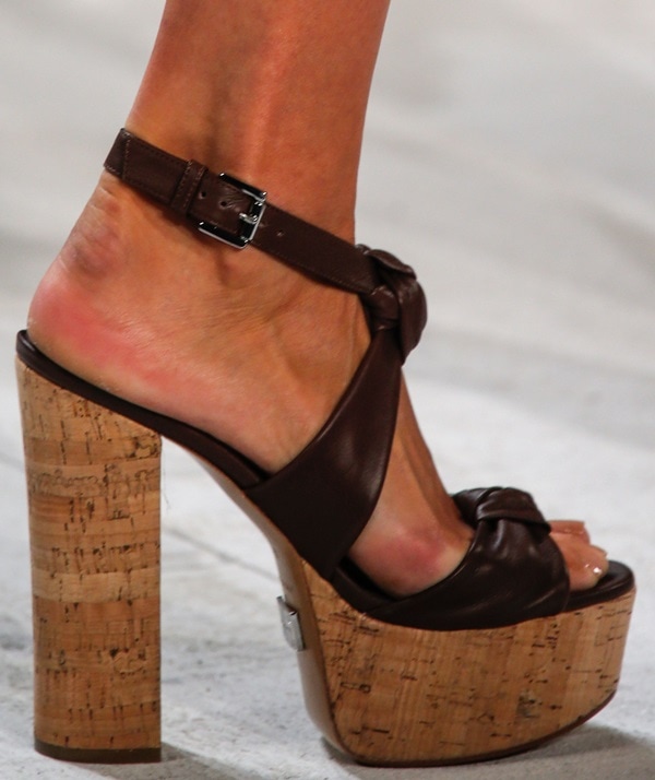 Strappy high-heel sandals with delicate floral embellishments from Michael Kors’ Spring 2014 runway collection