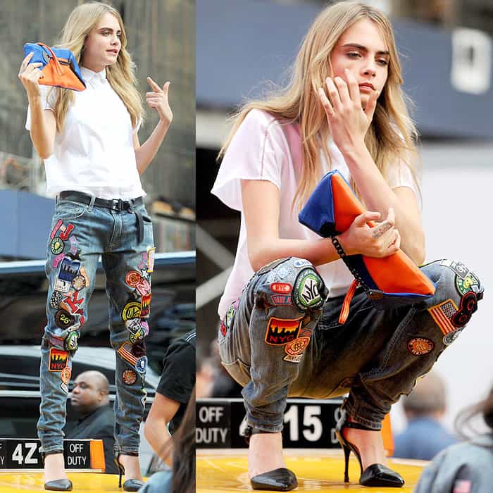 Cara Delevingne balances edgy and chic atop a yellow cab in Times Square, pairing DKNY’s patch-covered jeans with sleek black pointed-toe pumps during a high-energy photoshoot on October 14, 2013