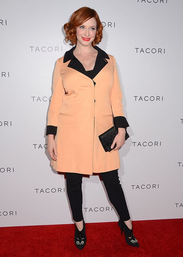 Christina Hendricks at Tacori's Annual Club Tacori 2013 event, showcasing a conservative yet elegant style in a Moschino coat, black top, and pants, complemented by her signature curled hair and striking red lipstick