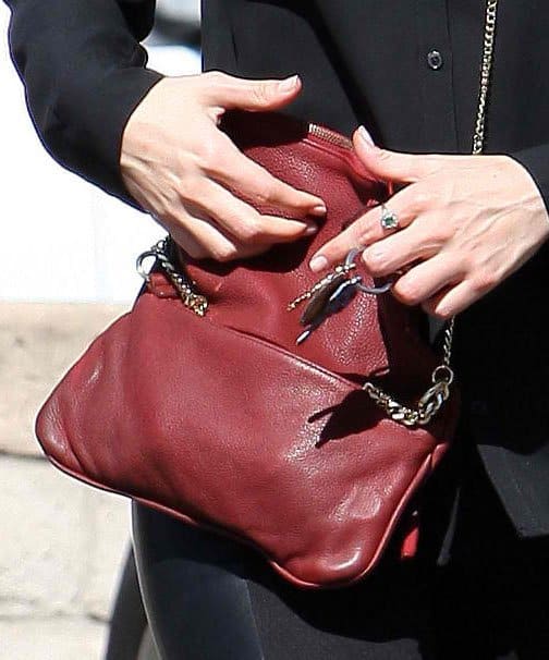 Emmy Rossum adds a pop of color with a red Zadig Voltaire Rock Tresse pochette, complementing her coral-red lips