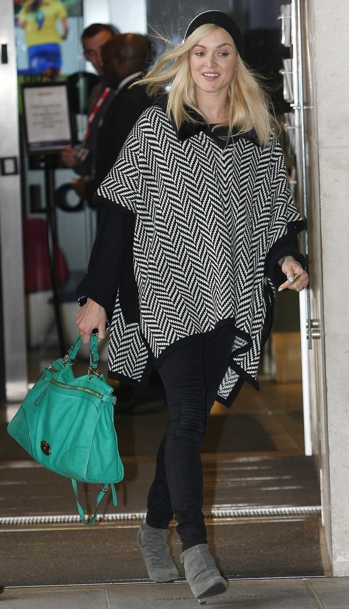 Fearne Cotton rocks a stylish beanie and a cozy black-and-white patterned poncho, perfect for fall