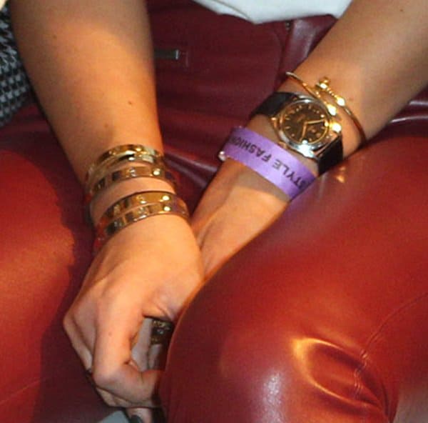 Kylie Jenner showcases a luxurious mix of Love bracelets and stacked bangles, paired with a classic gold watch, for a statement arm candy look