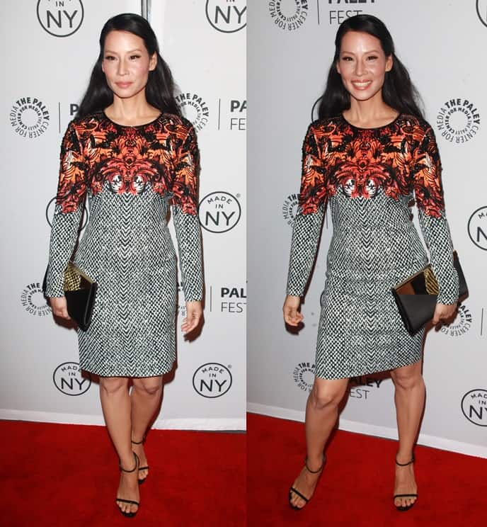 Lucy Liu dazzles in a vibrant Roberto Cavalli dress paired with a Jimmy Choo clutch and Saint Laurent sandals