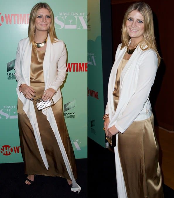 Mischa Barton attends the New York premiere of Showtime’s Masters of Sex at the Morgan Library Museum on September 26, 2013, wearing a gold satin Rubin Chapelle gown layered with a white cardigan and paired with minimalist black sandals and a metallic clutch