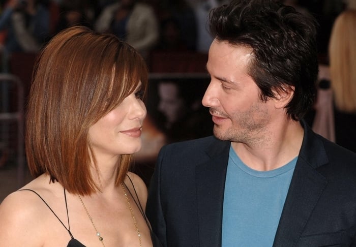 Sandra Bullock and Keanu Reeves share a warm moment on the red carpet, showcasing their undeniable chemistry both on and off the screen