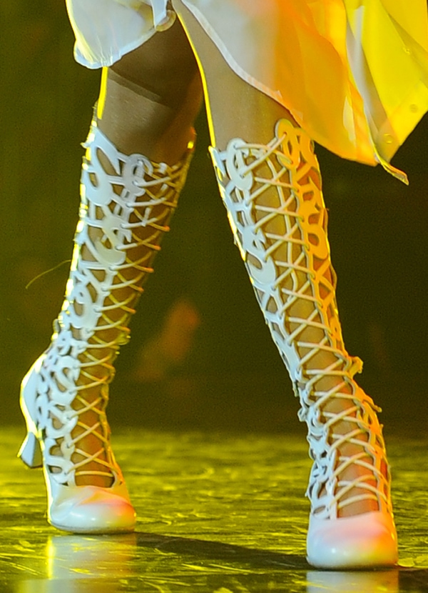 Selena Gomez wearing white lace-up gladiator boots with cutouts