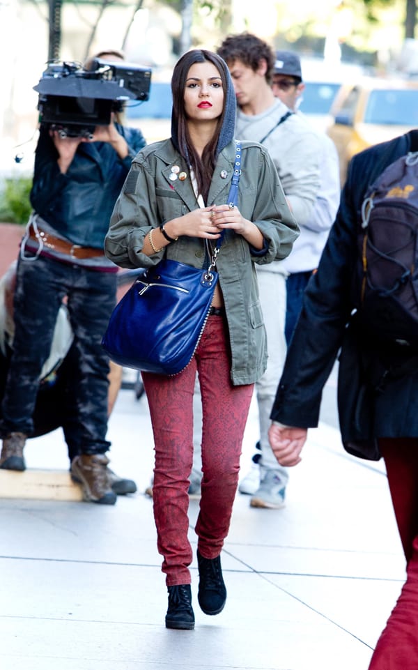 Victoria Justice, on the set of Naomi Ely’s No Kiss List on October 14, 2013, wore Current/Elliott paprika ankle skinny snake print jeans paired with a Vintage Renewal Surplus F2 olive army jacket