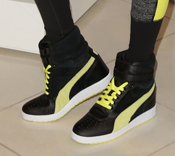 Alessandra Ambrosio wears a pair of Puma wedge sneakers during a Victoria's Secret promotion