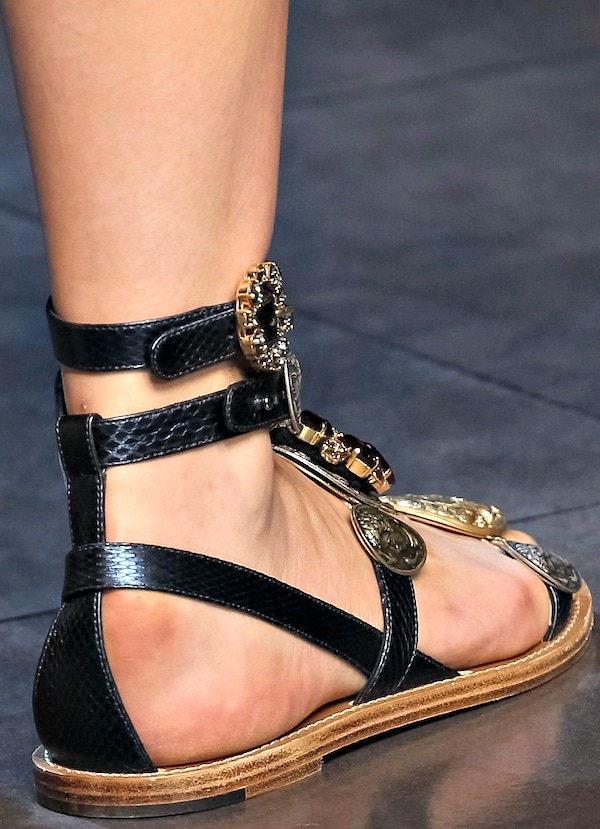 Black Dolce Gabbana flat sandals with gold coin embellishments and multiple straps