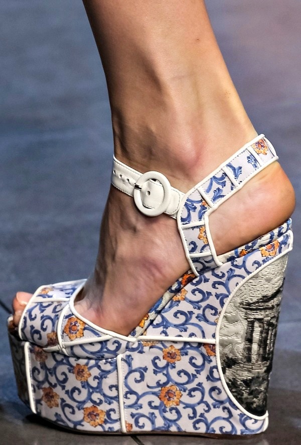White Dolce Gabbana wedge sandals with a blue and orange floral pattern and detailed architectural print on the platform