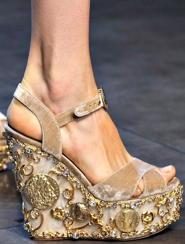 Velvet Dolce Gabbana wedge sandals adorned with ornate gold coins and intricate jeweled embellishments showcasing the brand's luxurious and detailed craftsmanship