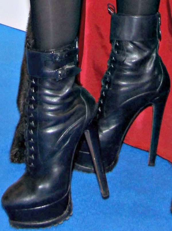 Lady Gaga's outfit is completed with her signature black lace-up platform boots, adding a touch of edgy glamour to her 'ARTPOP' listening party look
