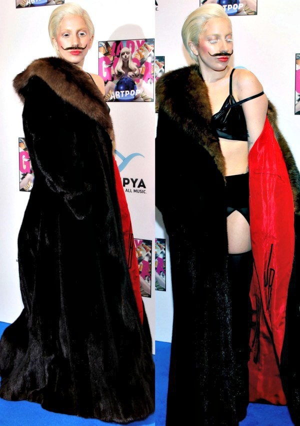 Lady Gaga stuns in black lingerie and a dramatic fur coat, complemented by a surreal Salvador Dali mustache at the 'ARTPOP' listening party