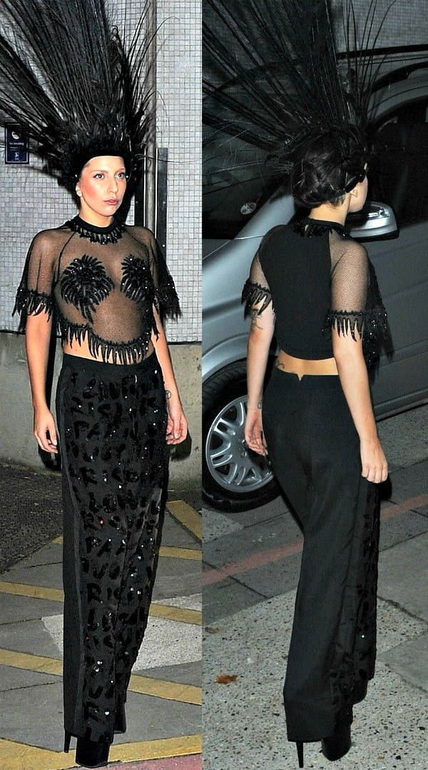 Lady Gaga leaving ITV Studios in London, United Kingdom, on October 29, 2013, wearing a daring all-black Louis Vuitton ensemble featuring a feathered headdress, sheer crop top, and embellished palazzo pants