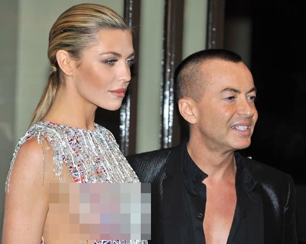 Abbey Clancy poses with designer Julien Macdonald, who created her daring Union Jack dress for Fashion for the Brave