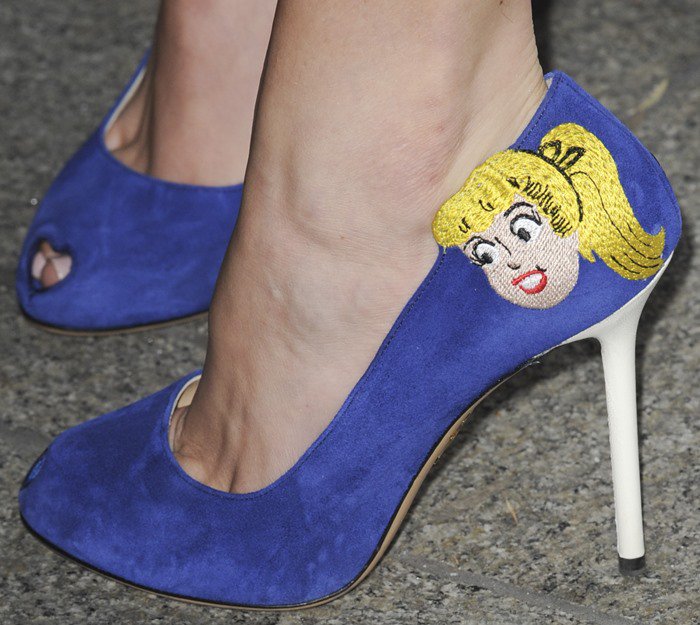 Bella Thorne showcases her playful side in Charlotte Olympia's bold Betty and Veronica pumps, featuring vibrant blue suede and whimsical embroidered details
