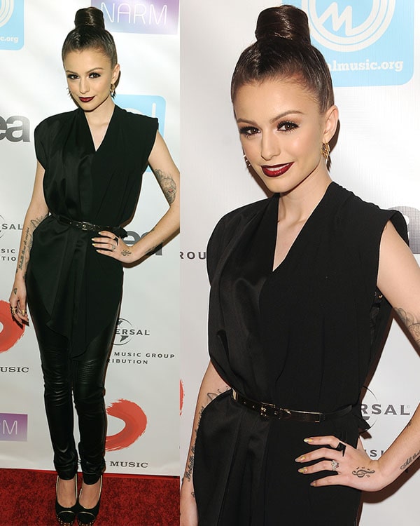 Cher Lloyd stuns in an all-black ensemble featuring a sleek belted tunic and leather pants paired with platform pumps and bold red lips at the NARM Music Biz Awards dinner party