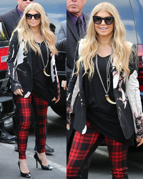 Fergie styled her long, voluminous blonde waves in loose curls, pairing them with oversized black sunglasses and a chic statement necklace