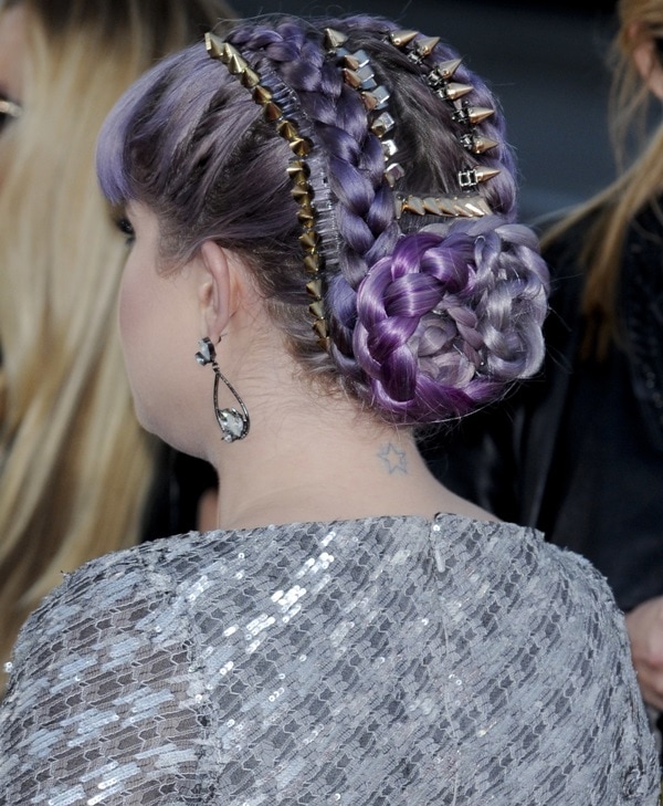 Kelly shows off her neck tattoo by wearing her lavender hair up in a braided and studded updo