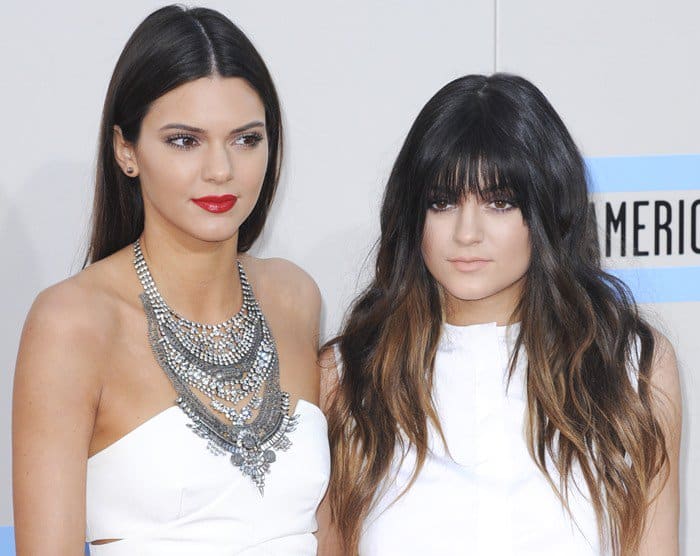 Kendall and Kylie Jenner at the 2013 American Music Awards, years after their cheerleading days at Sierra Canyon High School, showcasing early signs of their evolving red-carpet style