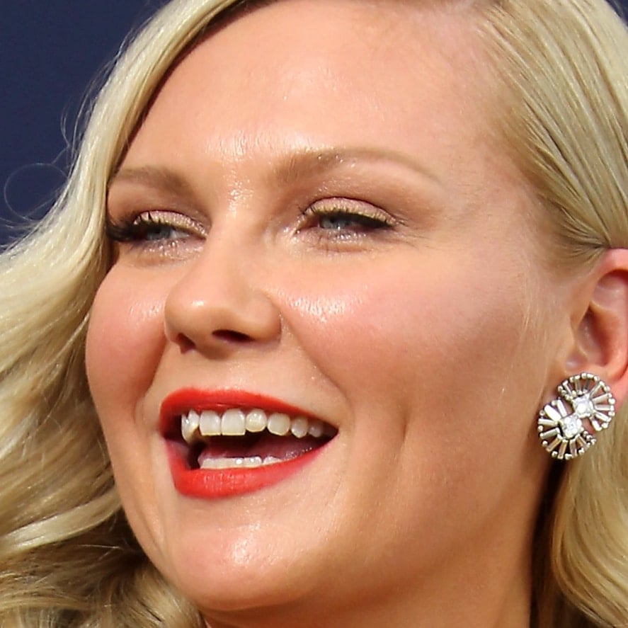 Kirsten Dunst shows off her signature smile and natural teeth while attending the 2018 Emmy Awards