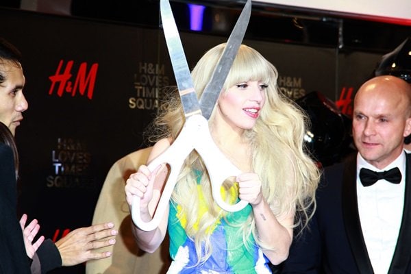 Lady Gaga holds a giant pair of scissors for the opening of the new HM store in Times Square