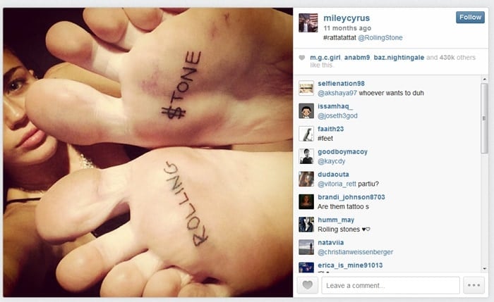 Miley Cyrus shows off her "Rolling $tone" foot tattoos, commemorating her first Rolling Stone magazine cover
