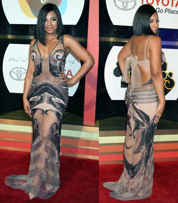 Ashanti dazzles in a sheer beaded dress by Reeve, elegantly paired with metallic heels that enhance the gown’s ethereal and glamorous red carpet appeal