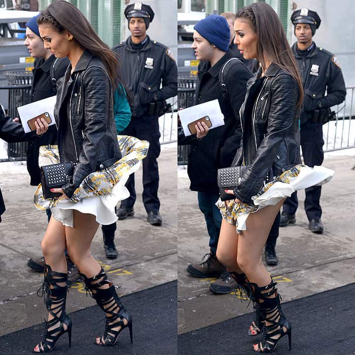 Victoria Justice battles a gusty wind in style, pairing her flared dress with a leather jacket and lace-up heels during New York Fashion Week
