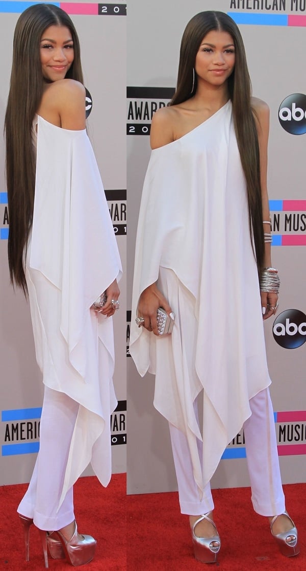 Zendaya stuns at the 2013 American Music Awards in a draped white Donna Karan Resort 2014 ensemble, elongating her frame with sky-high metallic silver Christian Louboutin Exagona platform sandals.
