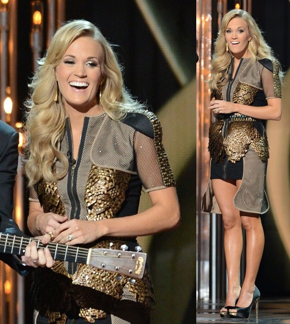 Carrie Underwood wears a black-and-gold outfit with mesh accents at the CMAs