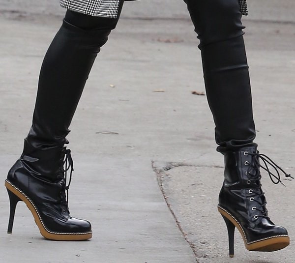 Gwen Stefani adds an edgy finish to her maternity look with sleek black L.A.M.B. “Nichol” lace-up booties featuring tall heels and wooden platforms