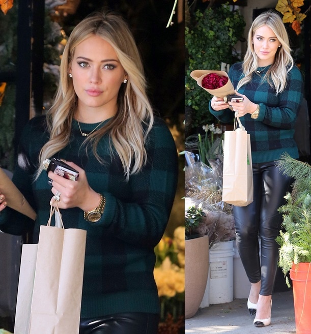 Hilary Duff exudes effortless polish while picking up flowers in Los Angeles on November 28, 2013, wearing a dark green sweater, sleek leather leggings, and sky-high black-and-white cap-toe pumps